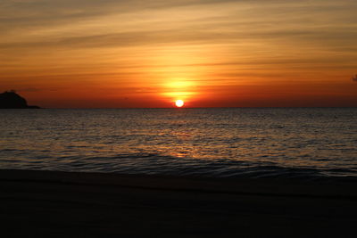 Scenic view of sea against orange sky