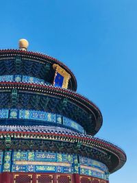 Low angle view of temple building against clear blue sky