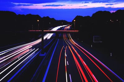 High angle view of light trails on road at night