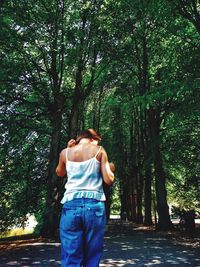 Rear view of woman walking in forest