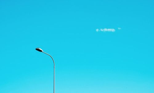 Low angle view of street light against clear blue sky