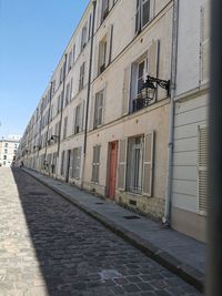 Street amidst buildings against sky