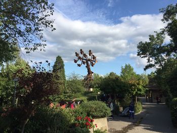 Statue amidst trees against sky