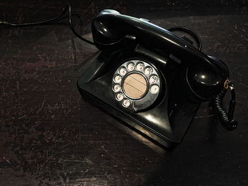 High angle view of old telephone on table