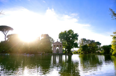 Scenic view of lake by trees against sky