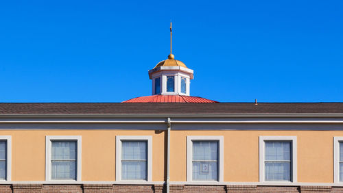 Low angle view of building against clear blue sky
