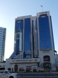 Buildings in city against clear sky