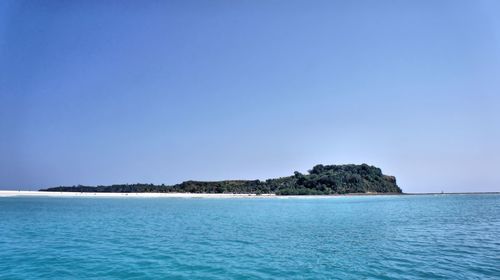 Scenic view of sea against clear blue sky