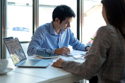 Young woman using laptop at office