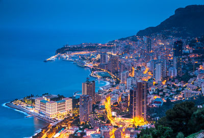 High angle view of townscape by sea against sky