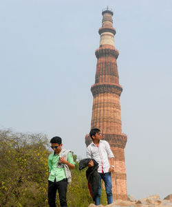 Full length of men standing against sky