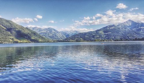 Scenic view of lake and mountains against sky