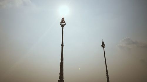 Low angle view of street lights against sky