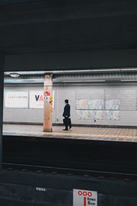 Rear view of woman at railroad station