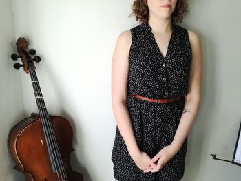 Full length of a young woman playing piano