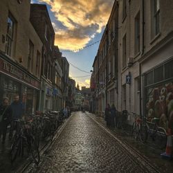 Buildings in city against cloudy sky