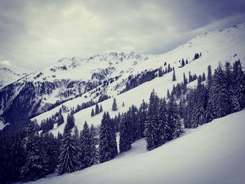 Scenic view of snow covered mountains against sky