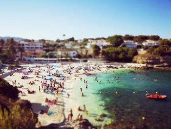 High angle view of people on beach against clear sky