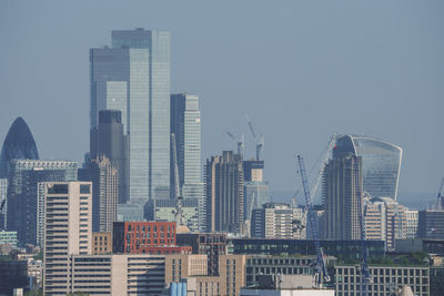 Modern buildings in city against clear sky