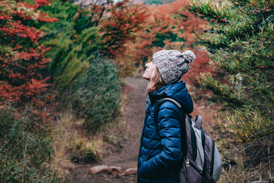 Side view of woman standing in the mountain in autumn 