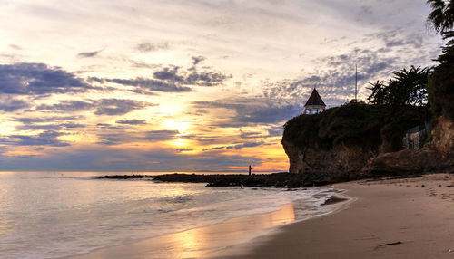 View of beach against cloudy sky