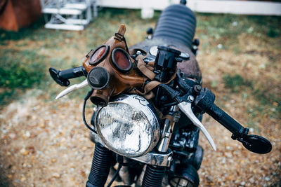 Motorcycle with gas mask parked on field