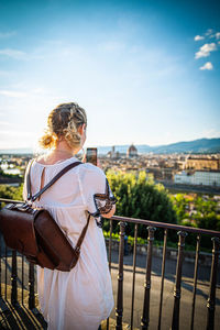 Rear view of woman looking at cityscape
