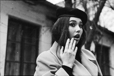 Portrait of young woman looking away outdoors