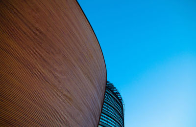 Low angle view of modern building against clear blue sky