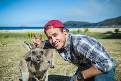 Portrait of man posing with kangaroo