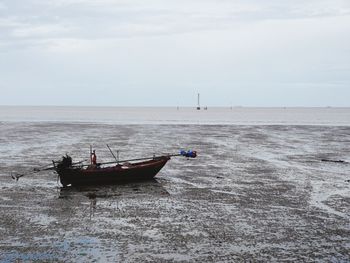 Fishing boat on sea against sky