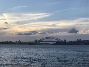 View of bridge over sea against cloudy sky