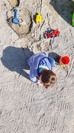 Directly above boy playing at beach