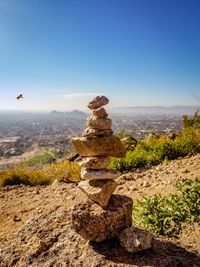 Stack of rocks on land against clear sky