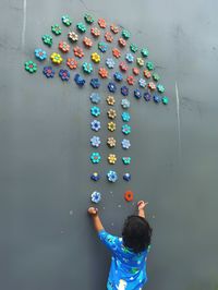High angle view of girl on multi colored wall