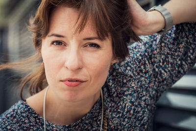 Adult young woman close-up face, outdoors portrait