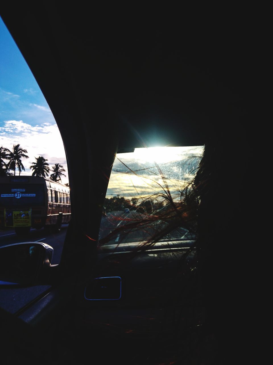 CLOSE-UP OF CAR AGAINST SKY SEEN THROUGH WINDSHIELD