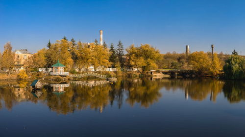 Autumn landscape with a lake and yellow trees in the village of ivanki, cherkasy region, ukraine