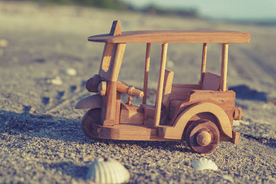 Close-up of toy car on sand at beach