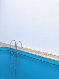High angle view of swimming pool against white wall