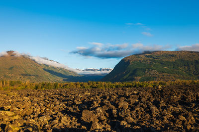 Scenic view of landscape against blue sky