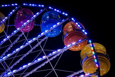 Low angle view of illuminated ferris wheel at night