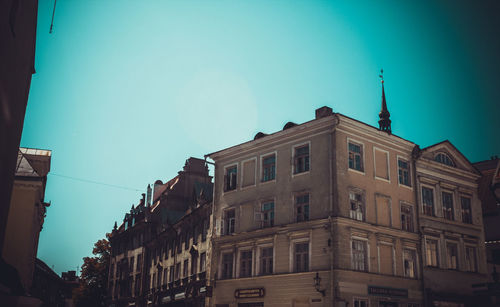 Low angle view of buildings against clear blue sky