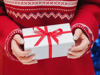 Midsection of woman holding gift box during christmas