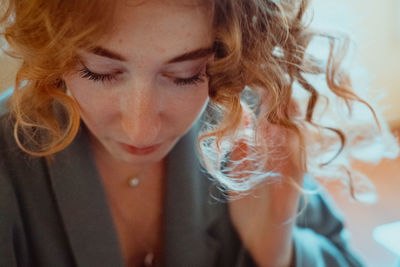 Close-up of young woman with curly hair