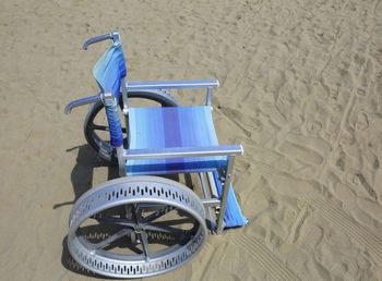 High angle view of empty deck chairs on sand