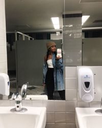 Full length of woman standing in bathroom