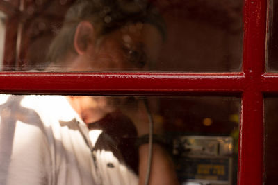 Rear view of woman seen through glass window