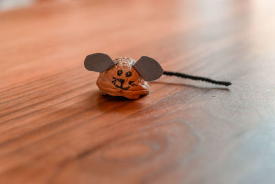 Close-up of a diy walnut shell mouse on a wooden table