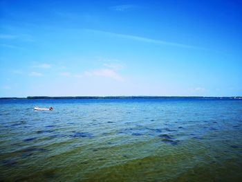 Scenic view of sea against blue sky